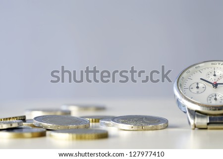 Time and Money - close up photo of one clock and some euro coins