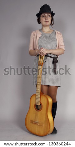 Close up photo of a Young woman playing the guitar