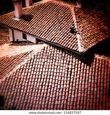 Red tile roof with chimney.