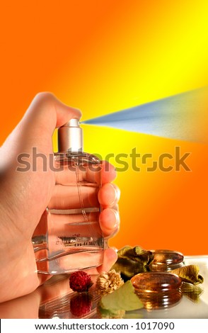 Bottle of Parfume in Hand - Spraying