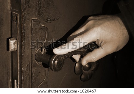 Hand on an antique door - opening