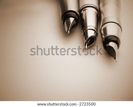 3 fountain pen isolated on brown.Great shoot.Great details