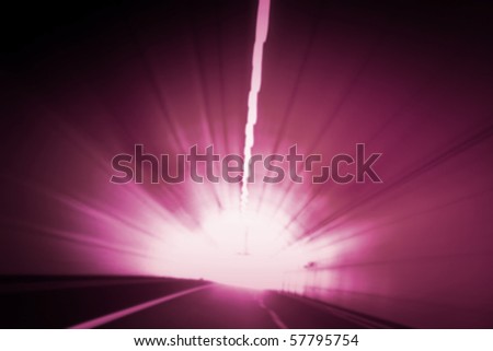 Car lights trails in a tunnel