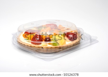 A fruit pie in a closed plastic transparent box