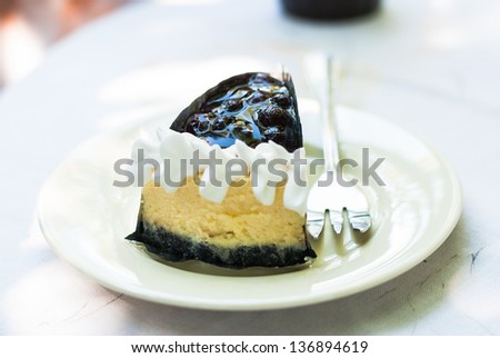 Cheesecake on a plate - Blueberry cheesecake slice with fork prepares to eat
