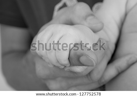 father giving hand to a child, black and white