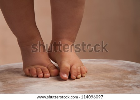 baby walking on wood floor
