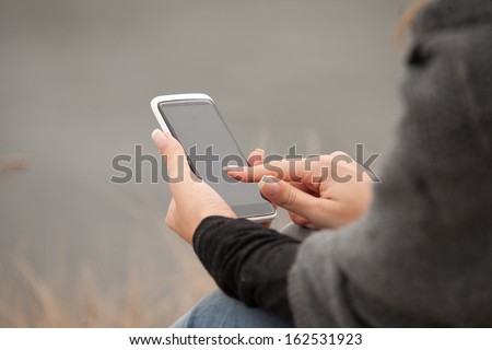 Mobile Phone on Human Hand by the Beach