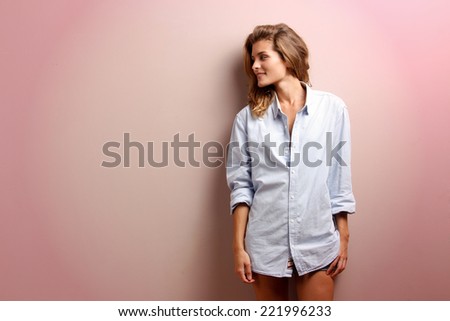 positive young woman in big man shirt with copy - space