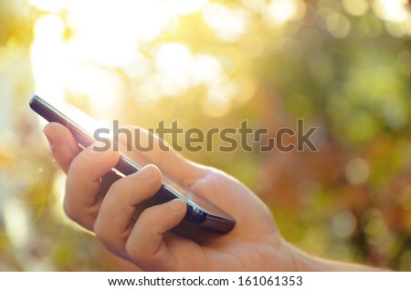 Man\'s hand using mobile smart phone