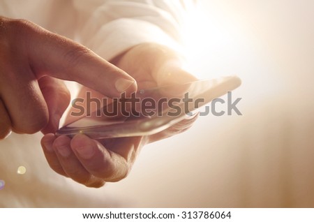 Closeup of businessman using modern smartphone. Image can be used for background, website banner, promotional materials, poster, presentation templates, advertising and printed materials.