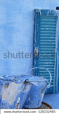 Blue painted shutters and old paint buckets in Nubian village, Aswan, Egypt