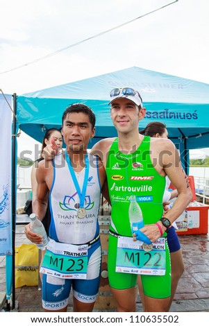 HUAHIN, THAILAND-AUG 19: First winner name's Simon Agoston (122) from Austria and second winner name's Jaray Jearanai (123) from Thailand in Queen's cup HuaHin International Triathlon 2012