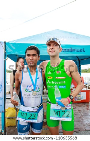 HUAHIN, THAILAND-AUG 19: First winner name\'s Simon Agoston (122) from Austria and second winner name\'s Jaray Jearanai (123) from Thailand in Queen\'s cup HuaHin International Triathlon 2012