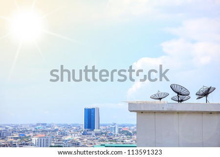 Black antenna communication satellite dish over sunny blue sky