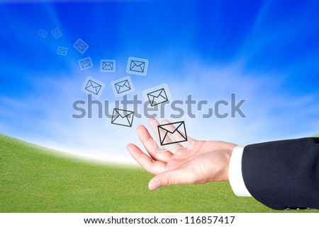 Business hand hold a message icons to sending out
