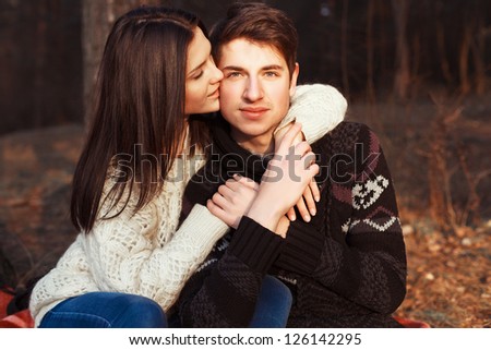 Outdoor summer portrait of young sensual couple. Boy hugs girl on the street in spring