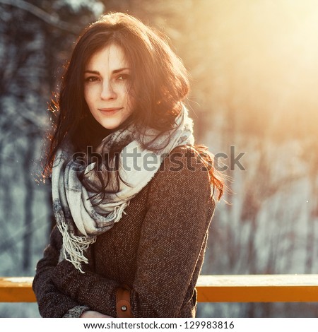 Outdoor Portrait Of Young Pretty Beautiful Woman In Cold Sunny Winter Weather In Park. Sensual Brunette Posing And Having Fun
