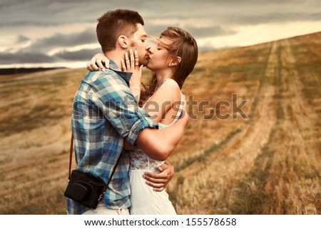 Young Beautiful Sensual Couple Outdoor Kiss In Windy Weather In Summer Corn Field
