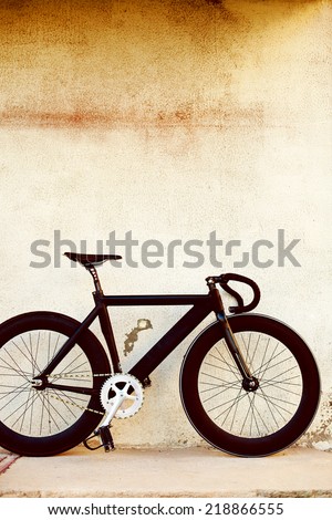 Urban background wall with black sport hipster fixed gear bicycle with fixed gear sport style cycling look