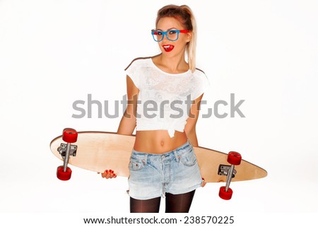 Portrait of pretty sexy young seductive woman posing with longboard desk on white background having fun and showing tongue