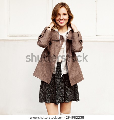 Pretty young smiling woman posing outdoor in autumn city urban style portrait on white background