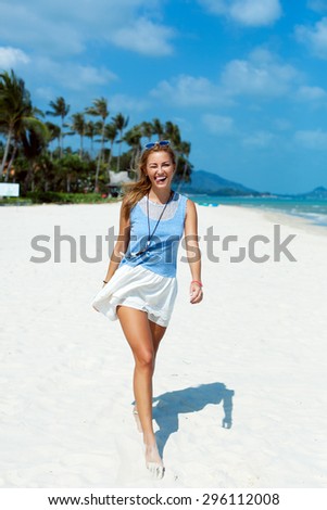 Nice smiling happy woman outdoor summer portrait walking on the beach having fun on vacation on tropic island