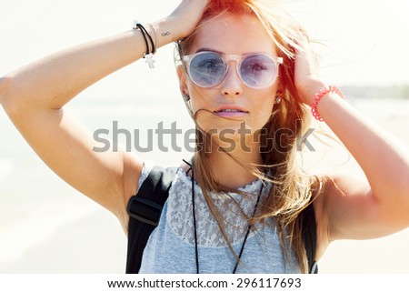 Outdoor summer fashion colorful stunning sensual portrait of young blonde pretty woman posing on sunshine beach weather