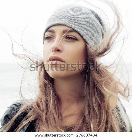 Young woman outdoor summer sensual sad mood cold weather portrait posing on the wind in hat fashion style