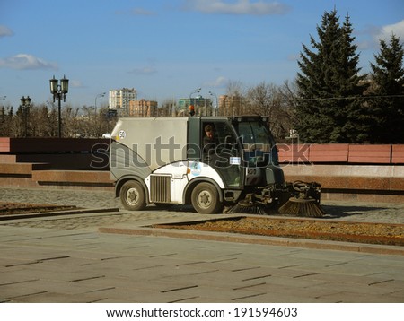 MOSCOW - MARCH 14: A sweeping machine cleaning the Victory Park, on March 14, 2014 in Moscow, Russia.