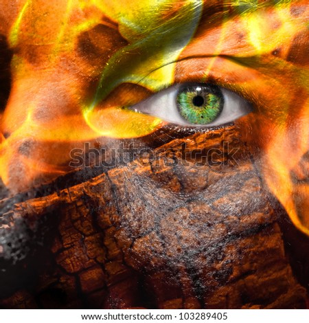 Face with green eye  painted with flames and wood