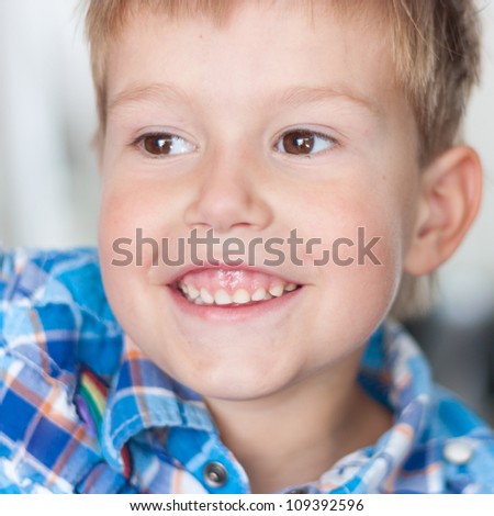 Close up of handsome little boy with a big smile on his face and a twinkle in his eyes