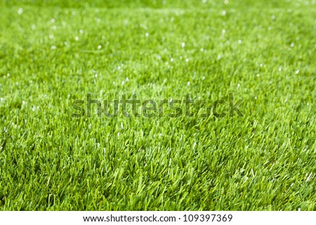 Close up of green  artificial grass or turf also called astro turf and is made of synthetic fibers