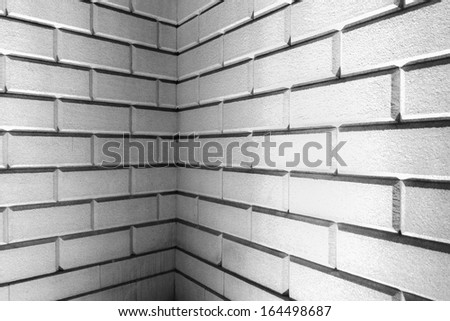 Brick wall corner detail made with big bricks lit up with white lighting