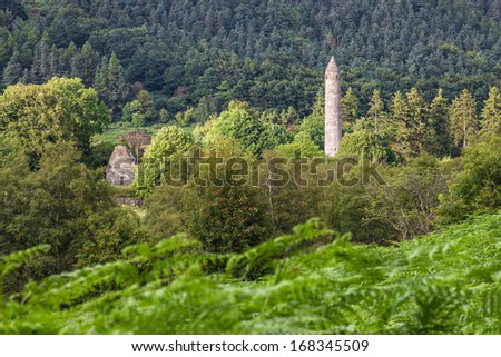 GLENDALOUGH, IRELAND - DECEMBER 22, 2013: The Round Tower in the Monastic City located in Glendalough Ireland is perhaps the most noticeable monument, the Round Tower is about 30 metres high.