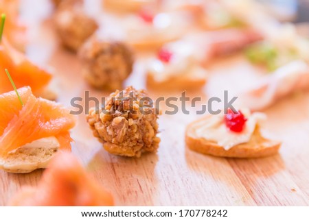 Variety of Hors D\'oeuvres on a wooden platter