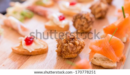 Collection of Hors D\'oeuvres on a wooden platter