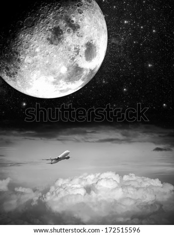 Big moon and airplane above the clouds