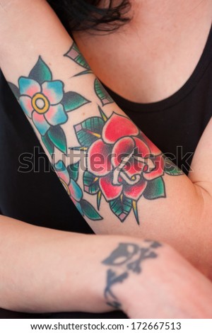 Colorful flower tattoo on a woman\'s arm