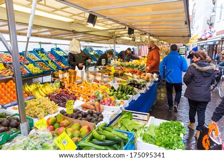ZWOLLE, THE NETHERLANDS - FEBRUARY 1, 2014: Unidentified peope buying groceries at the street market in Zwolle. In the Netherlands there are 18,000 merchants realizing a 2.6 billion turn over.