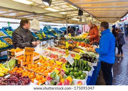 ZWOLLE, THE NETHERLANDS - FEBRUARY 1, 2014: Unidentified people buying groceries at the street market in Zwolle. In the Netherlands there are 18,000 merchants realizing a 2.6 billion turn over.
