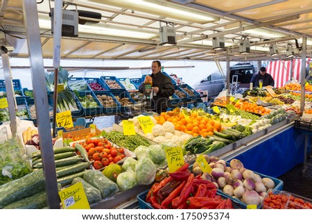 ZWOLLE, THE NETHERLANDS - FEBRUARY 1, 2014: Unidentified merchant selling groceries at the street market in Zwolle. In the Netherlands there are 18,000 merchants realizing a 2.6 billion turn over.