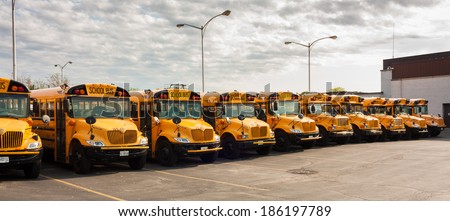 CHICAGO - MAY 25, 2012: Yellow school buses parked in line at their depot. Each school day in 2012 approximately 468,000 school buses transport 28.8 million children to and from school and activities.