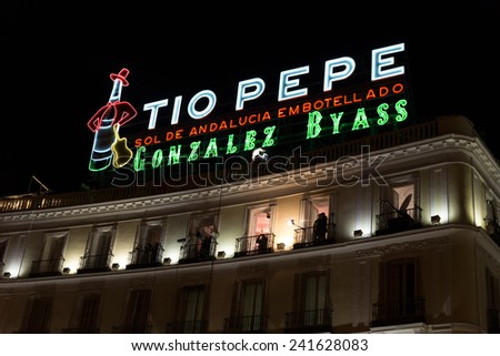 MADRID, SPAIN - DECEMBER 31, 2014: The Tio Pepe sign at Puerta del Sol in Madrid on December 31 in Madrid. Cameras situated on the balconies are set up to film New Year celebrations on Puerta del Sol.