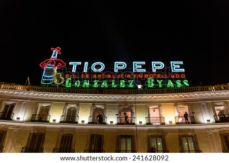 MADRID, SPAIN - DECEMBER 31, 2014: Tio Pepe sign at Puerta del Sol in Madrid on December 31 in Madrid. Cameras situated on the balconies are set up to film New Year celebrations on Puerta del Sol.