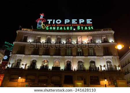 MADRID, SPAIN - DECEMBER 31, 2014: Tio Pepe sign at Puerta del Sol in Madrid on December 31 in Madrid. Cameras situated on the balconies are set up to film New Year celebrations on Puerta del Sol.