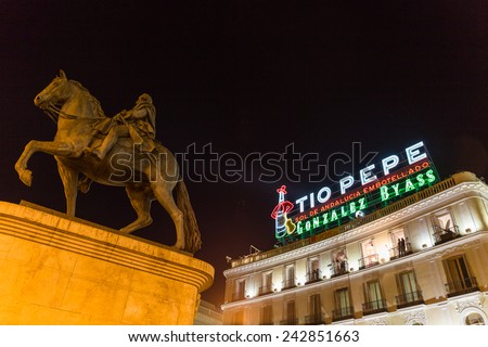 MADRID - DECEMBER 31, 2014: Tio Pepe sign and Monument to King Charles III at Puerta del Sol on December 31 in Madrid. Cameras situated on the balconies are set up to film New Year celebrations