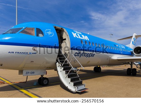 AMSTERDAM - 19 JULY, 2014: An Air France KLM Cityhopper Fokker 70 at Schiphol Airport is getting ready for the flight to Toulouse.