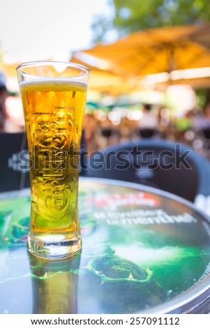 TOULOUSE, FRANCE - JULY 22, 2014: A pint of Carlsberg served at Le Wallace cafe. Le Wallace is one of ToulouseÃ¢??s hot places because of its  perfect location on Place Saint-Georges.