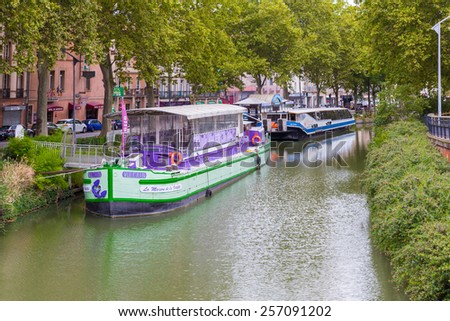 TOULOUSE, FRANCE - JULY 21, 2014: The Canal du Midi is a 241 km long canal in Southern France. The canal has been used to transport passengers and goods but is now used primarily for recreation.